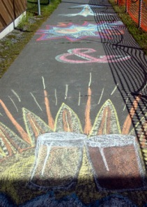 Photo courtesy of Joe Kashi. Colorful chalk art beckons the way to the festival area at the Soldotna Sports Center.